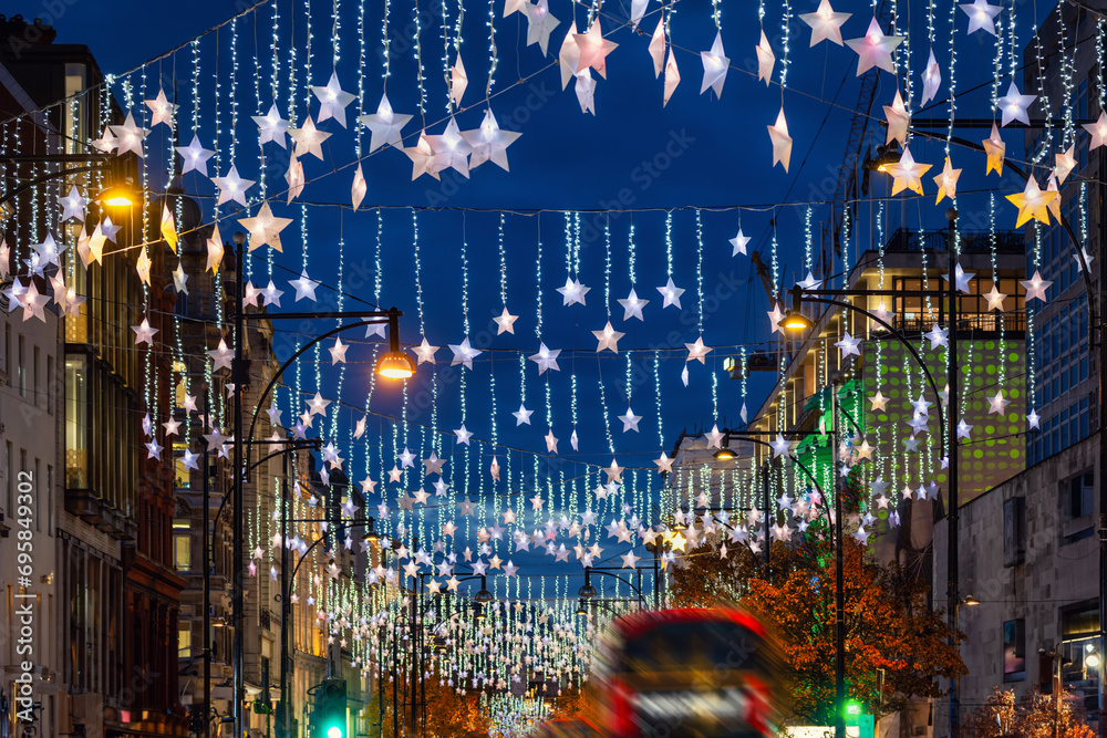 Wall mural festive christmas decorations in the streets of london with red bus traffic during night time - Wall murals