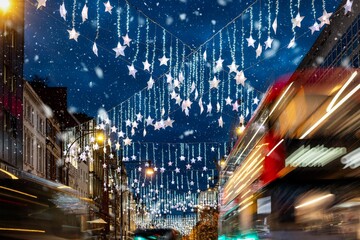 Festive decorated streets in London, England, with Christmas fairy lights, red bus traffic and snowfall