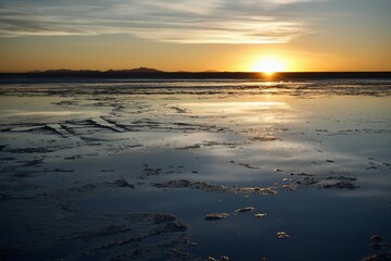 Sun Setting over the Uyuni Salt Flat, Bolivia, reflected in the saline water. 
