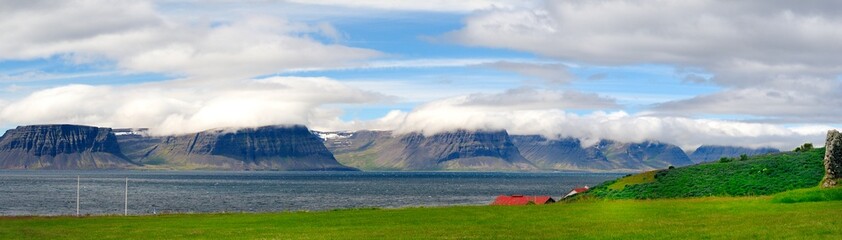 Naklejka premium Red farm building and the fjord