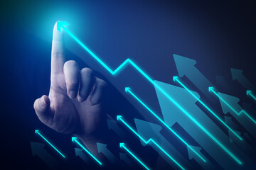 Businessman's hand showing rising arrow on dark background. concepts of business that express the...
