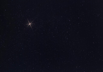 Copy space next to a brigth star on Christmas Eve