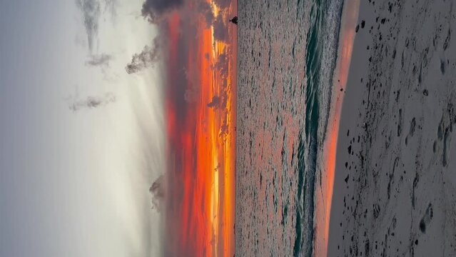 Stunning vivid deep orange and red beach sunset: Malahini Kuda Bandos, Maldives