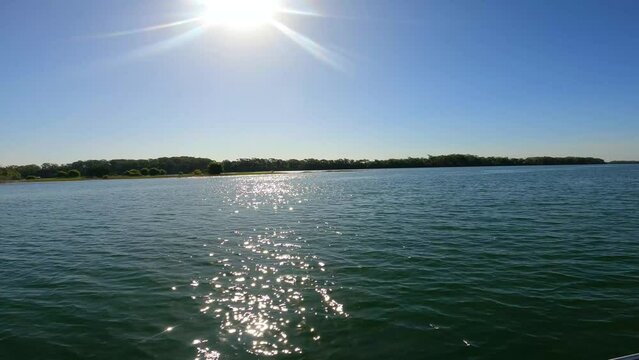 Riding a boat on amazing parana river with the sun,reflecting on river,Brasil