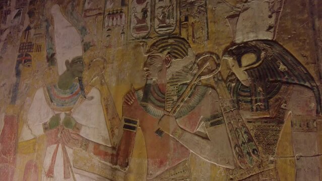 Luxor, Egypt: Interior view of the famous Seti the first tomb that is decorated with gods figures and hieroglyphs  in the valley of Kings in Luxor in Egypt. Shot with a tilt down.