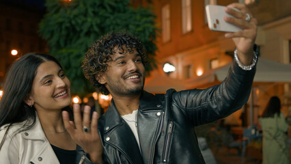 Indian Arabian couple love guy girl woman man friends boyfriend girlfriend night evening city urban talking mobile phone webcam video call record conference vlog blog smiling laughing greeting hello