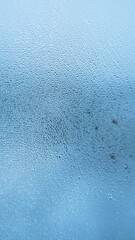 Condensation on window glass in frosty winter weather. Background in the form of small drops on the glass.