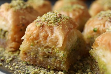 Delicious fresh baklava with chopped nuts on plate, closeup. Eastern sweets