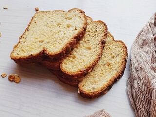 slices of wholemeal bread on blurred wooden background