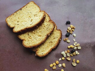 slices of wholemeal bread on brown background