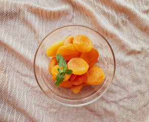 glass jar with dried apricots and  brown background