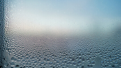 Condensation on window glass in frosty winter weather. Background in the form of small drops on the...