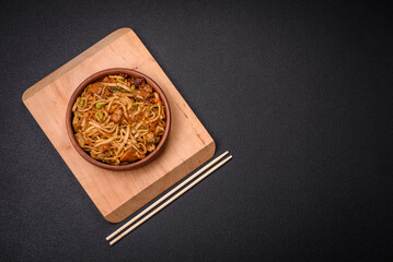 Delicious asian udon dish with vegetables, mushrooms, salt and spices