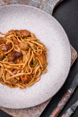 Delicious asian udon dish with vegetables, mushrooms, salt and spices