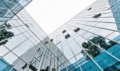 Low angle view of modern office building exterior - obrazy, fototapety, plakaty