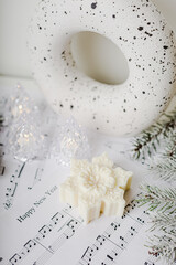 White and green snowflakes, candles, Christmas concept, decoration, music notes, white round vase, lights