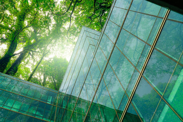 Eco-friendly building in modern city. Sustainable glass office building with trees for reducing...