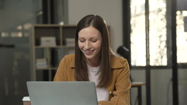 smiling Caucasian university student with a tablet, engaging in online learning, possibly studying liberal arts.