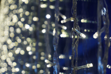 Bokeh. Close-up Christmas tree. An abstract background of lights in the city at night.