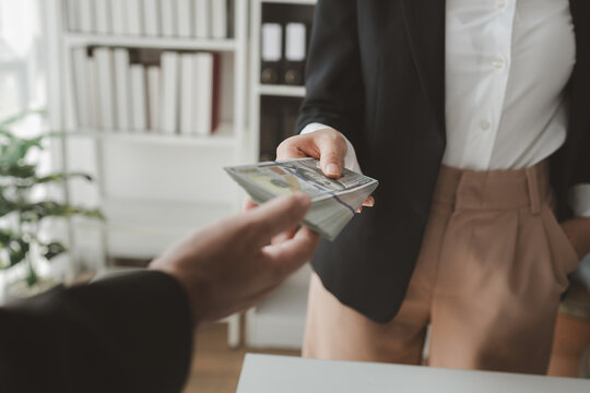 Handing stacks of money to each other in the office, Give money to officials for some business-related reason, Receive kickbacks from corruption in business.