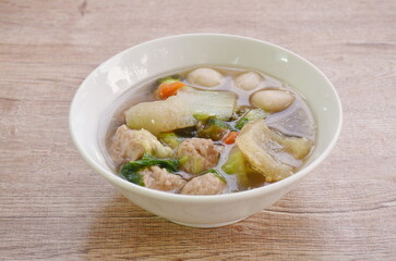 boiled chop pork with fish ball couple cabbage topping seaweed in clear soup on bowl