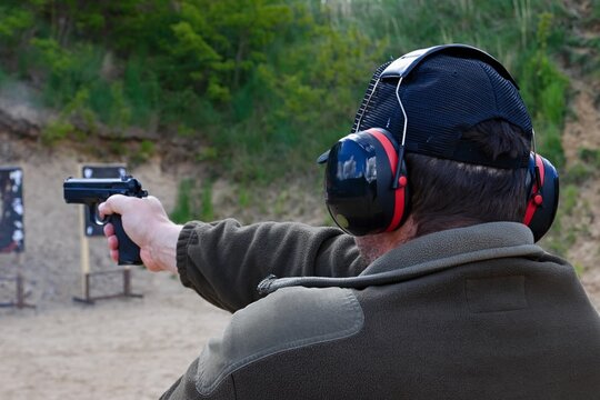 police officers practice shooting a pistol at a target