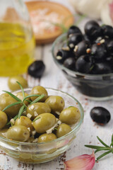 Black and green olives in glass bowls