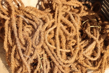 Bunch of scrambled Brown coconut rope under bright sunlight