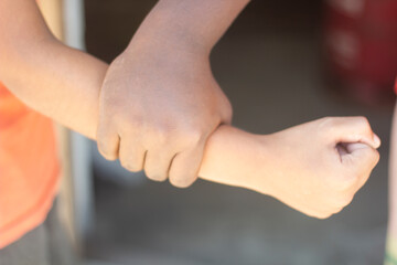 A man holding another man's hand and blurred background
