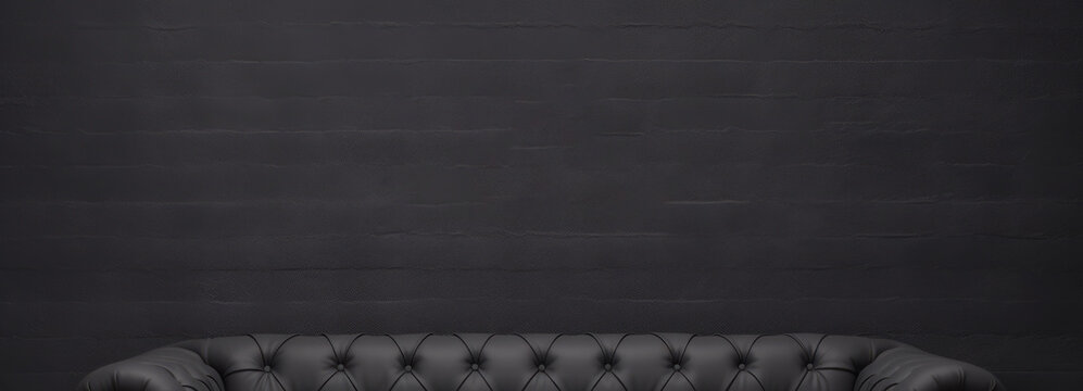 Panorámica de pared oscura estilo mockup con leve detalle de un sofá de cuero.