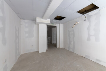 New empty room under construction. Plaster walls. New home. Concrete walls. Interior renovation.