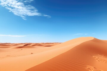 A panoramic view of a desert with sand dunes and a clear blue sky