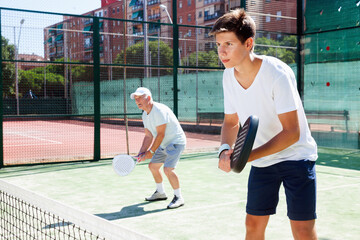 Padel players of different generations playing padel court