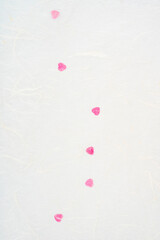 White mulberry paper with red hearts.
