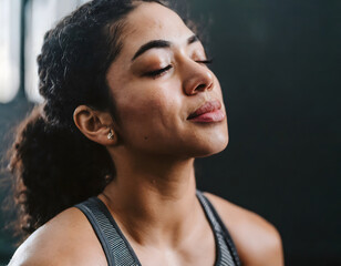 brunette girl with closed eyes meditating in a yoga training - obrazy, fototapety, plakaty
