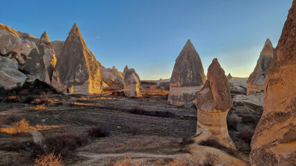 Enchanting view of the fairy chimneys in the Red Valley, Cappadocia—a testament to nature's...