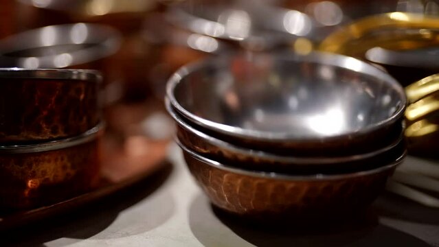 empty and clean metal bowls in kitchen of restaurant, closeup view of tableware in restaurant