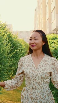 Happy asian woman in romantic dress runs