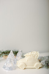 Miracle light candle car with Christmas tree on a top. White background, copy space. Winter Fairy tale concept. Minimalism, scandinavian decor.