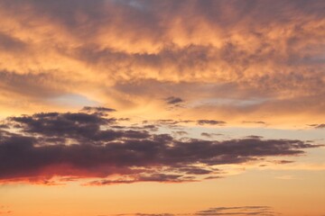 Twilight sunset sky. Nature background. Soft golden clouds. Sunrise early morning. Dramatic pastel panorama. Aerial view. Abstract landscape texture