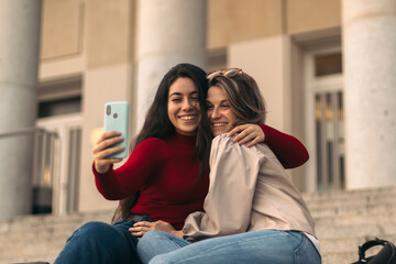 Two student girls hugging taking a selfie