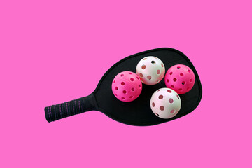 Pink Pickle balls and pink pickle ball paddle with pink background.