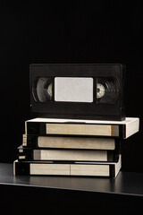 Pile of VHS video cassettes. Vintage media. Dark back