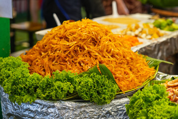 Cabbage noodles with fresh salad on a street market stall.