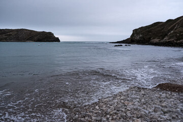 Lulworth Cove and beach view at winter day. Lulworth Cove bay, beach and cliffs view . The Jurassic Coast is a World Heritage Site on the English Channel coast of southern England. Dorset, UK. public 