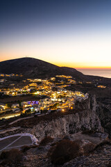 View over the Hora of Folegandros by night from the top of a cliff. Cyclades of Greece.  - 695943153