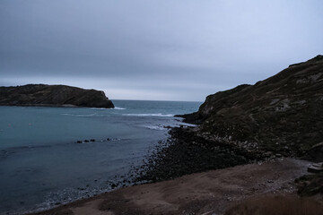 Fototapeta premium Lulworth Cove and beach view at winter day. Lulworth Cove bay, beach and cliffs view . The Jurassic Coast is a World Heritage Site on the English Channel coast of southern England. Dorset, UK. public 