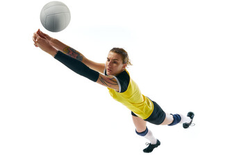 Dynamic competitive young woman, volleyball player in motion during game, hitting ball isolated over white background. Concept of sport, competition, active and healthy lifestyle, hobby