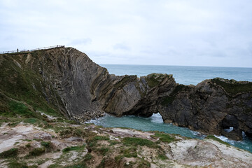 Fototapeta na wymiar Lulworth Cove cliffs view on a way to Durdle Door. The Jurassic Coast is World Heritage Site on the English Channel coast of southern England. Dorset, UK. Jurassic coast view in Dorset, UK. Stair Hole