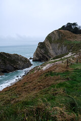 Lulworth Cove cliffs view on a way to Durdle Door. The Jurassic Coast is World Heritage Site on the English Channel coast of southern England. Dorset, UK. Jurassic coast view in Dorset, UK. Stair Hole